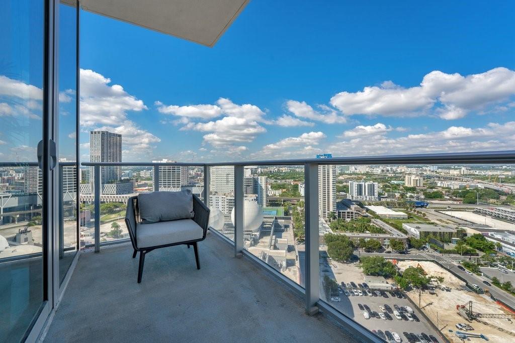 851 Northeast 1st Avenue, Unit 2202 Miami, FL 33132 - Photo 18 of 56 a view of a chairs and table in a balcony