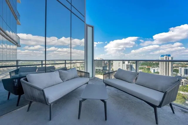 a balcony with furniture and city view