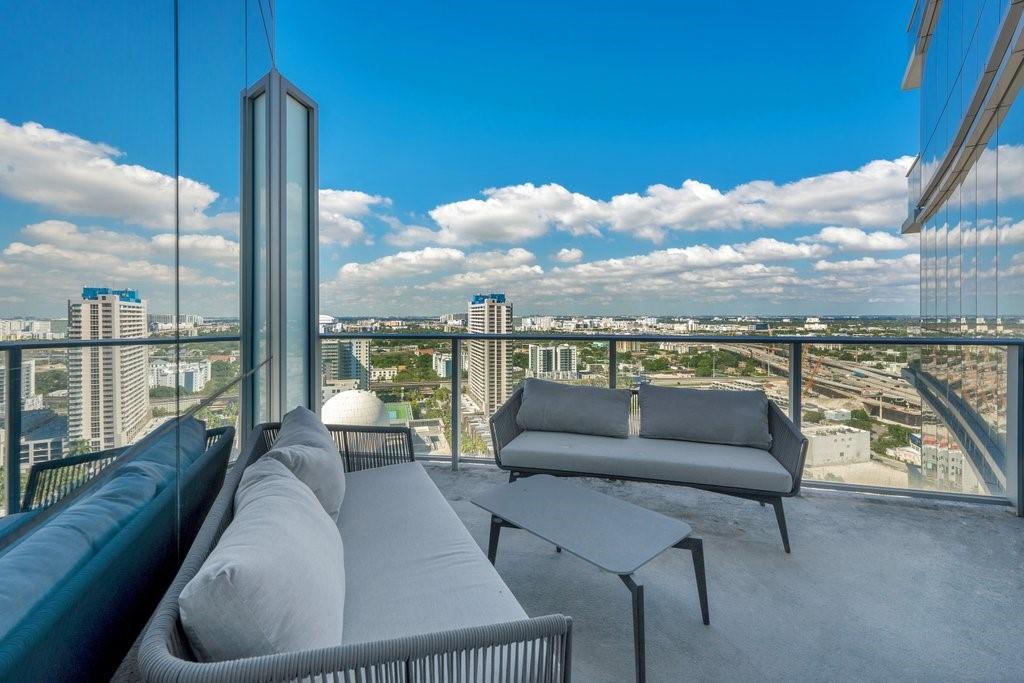 851 Northeast 1st Avenue, Unit 2202 Miami, FL 33132 - Photo 20 of 56 a balcony with furniture and city view