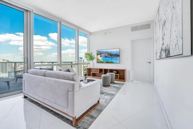 a living room with furniture and a large window