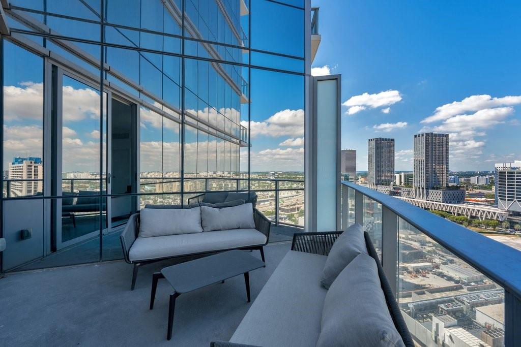 851 Northeast 1st Avenue, Unit 2202 Miami, FL 33132 - Photo 21 of 56 a living room with furniture and a large window