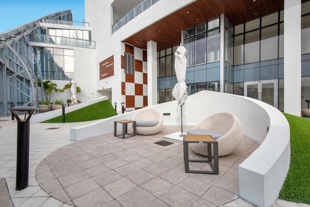 851 Northeast 1st Avenue, Unit 2202 Miami, FL 33132 - Photo 28 of 56 a view of a patio with a table and chairs