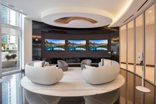 a living room with large window and furniture