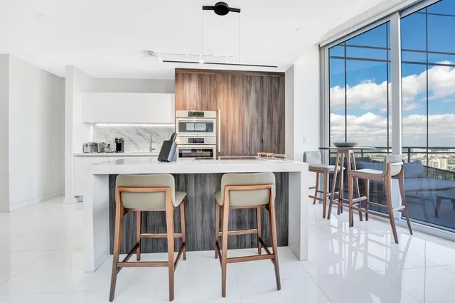 a kitchen with a table chairs stove and sink