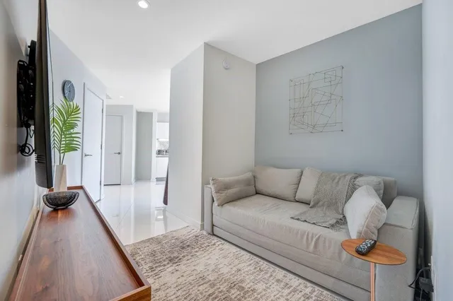a living room with furniture and a rug
