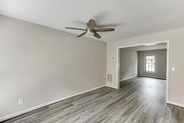 wooden floor in an empty room with a window