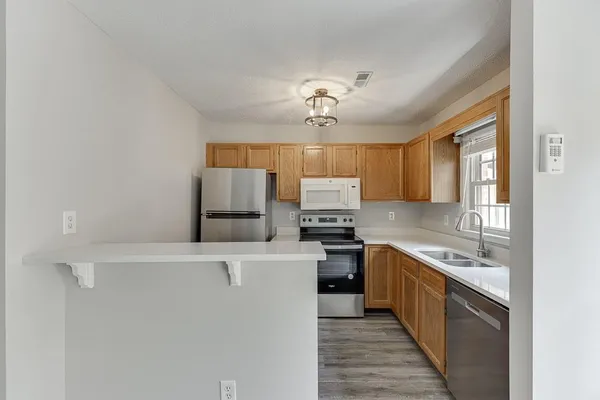 a kitchen with stainless steel appliances a sink stove and refrigerator
