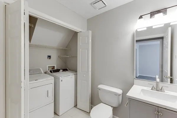 a bathroom with a toilet sink and mirror