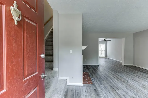 a view of hallway with wooden floor