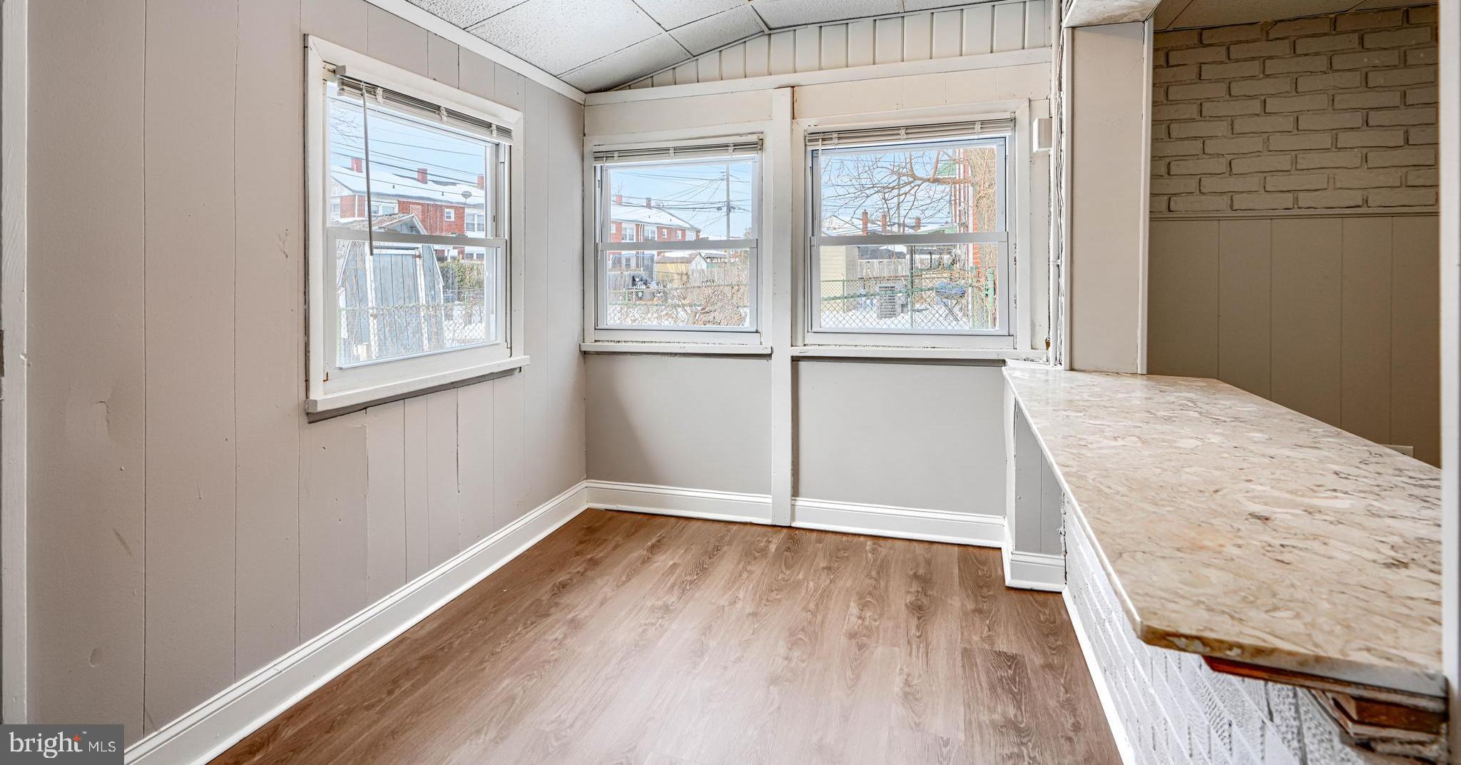 2014 Larkhall Road Dundalk, MD 21222 - Photo 19 of 44 a view of an empty room with wooden floor and a window