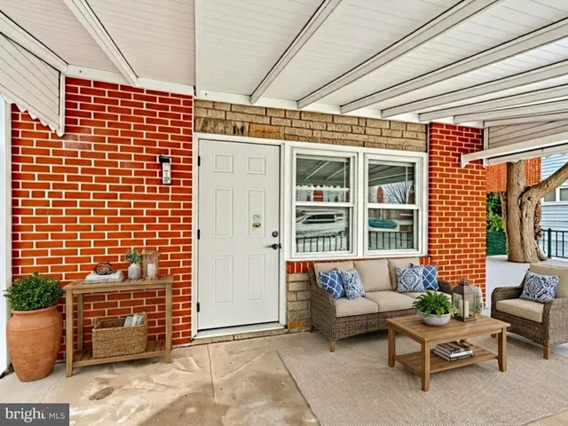 a view of an empty room with wooden floor and entryway