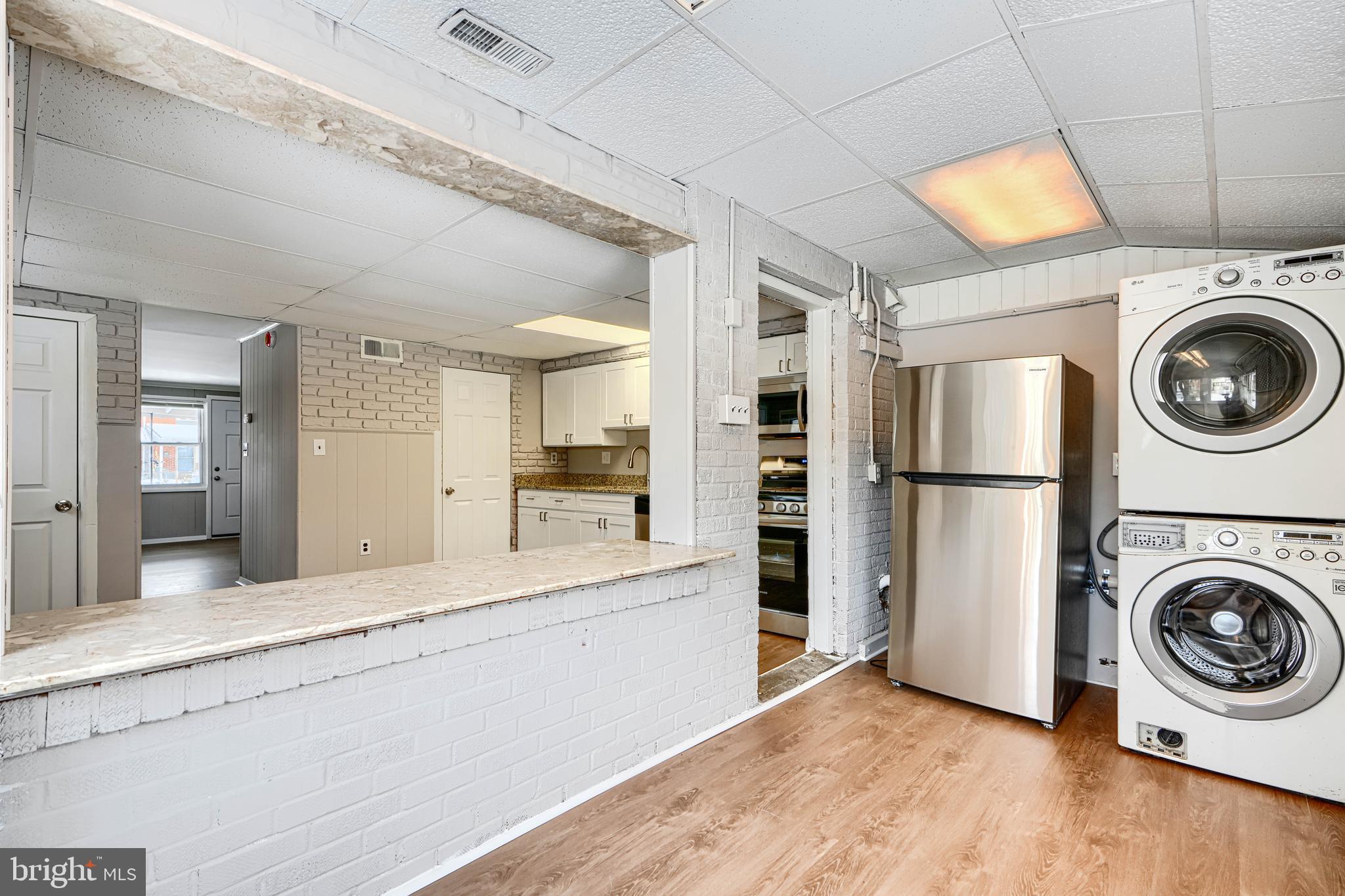 2014 Larkhall Road Dundalk, MD 21222 - Photo 21 of 44 a view of a kitchen with a stove fridge and wooden floor