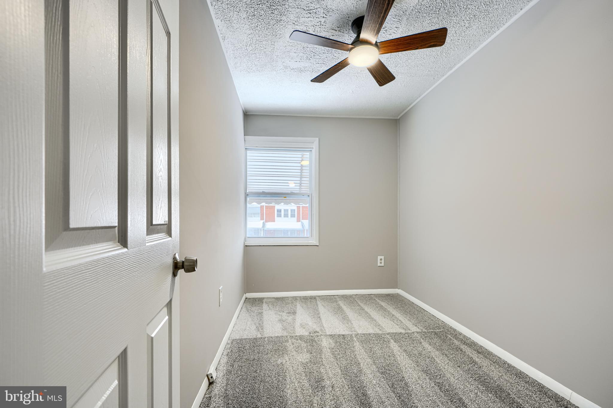 2014 Larkhall Road Dundalk, MD 21222 - Photo 23 of 44 an empty room with a window and a fan