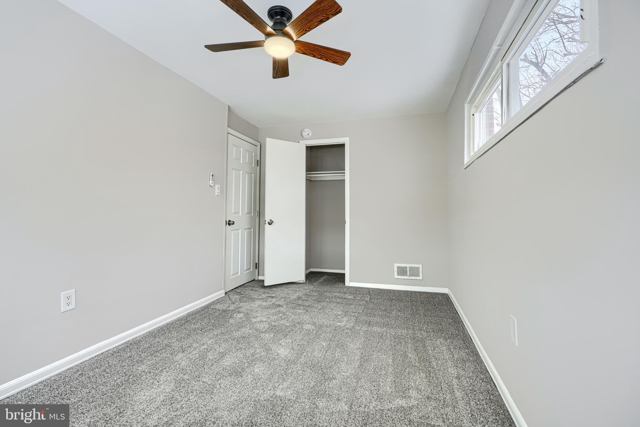 2014 Larkhall Road Dundalk, MD 21222 - Photo 30 of 44 an empty room with windows and fan