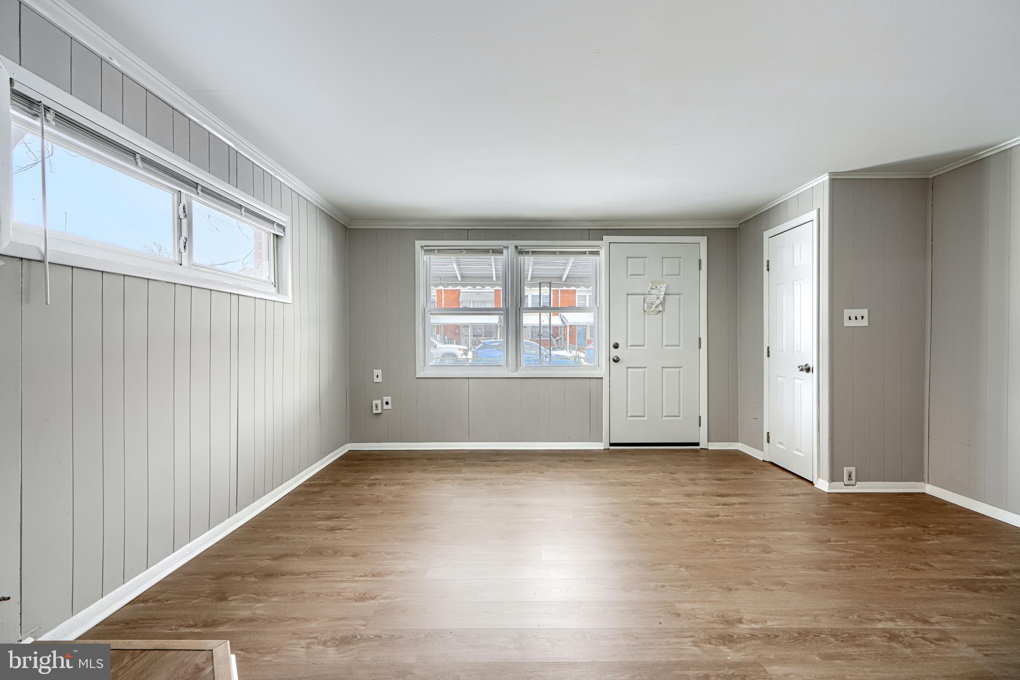 2014 Larkhall Road Dundalk, MD 21222 - Photo 7 of 44 an empty room with wooden floor and windows