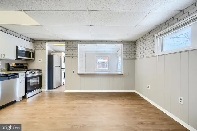 a view of a dining room with furniture and a kitchen counter space