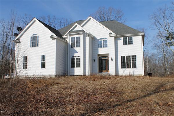 184 Rice Corner Road Brookfield, MA 01506 - Photo 1 of 15 a front view of a house with a yard