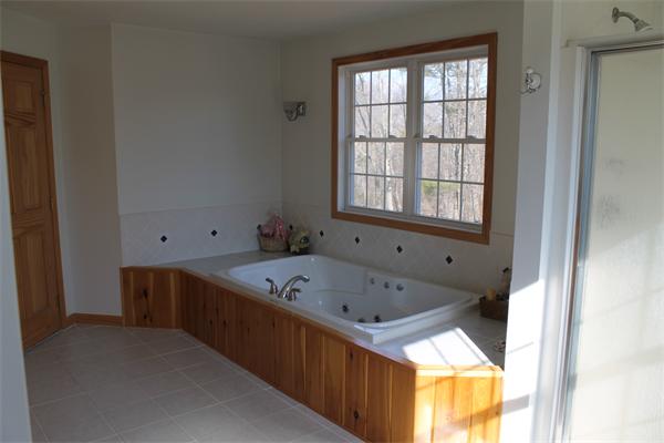 184 Rice Corner Road Brookfield, MA 01506 - Photo 14 of 15 a bathroom with a tub sink and mirror