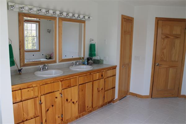 184 Rice Corner Road Brookfield, MA 01506 - Photo 15 of 15 a bathroom with double vanity sink and a mirror