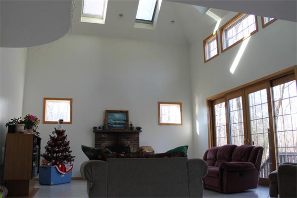 184 Rice Corner Road Brookfield, MA 01506 - Photo 4 of 15 a living room with furniture a large window and a flat screen tv