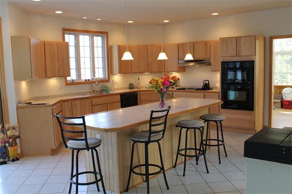184 Rice Corner Road Brookfield, MA 01506 - Photo 9 of 15 a kitchen with stainless steel appliances kitchen island granite countertop a table and chairs in it