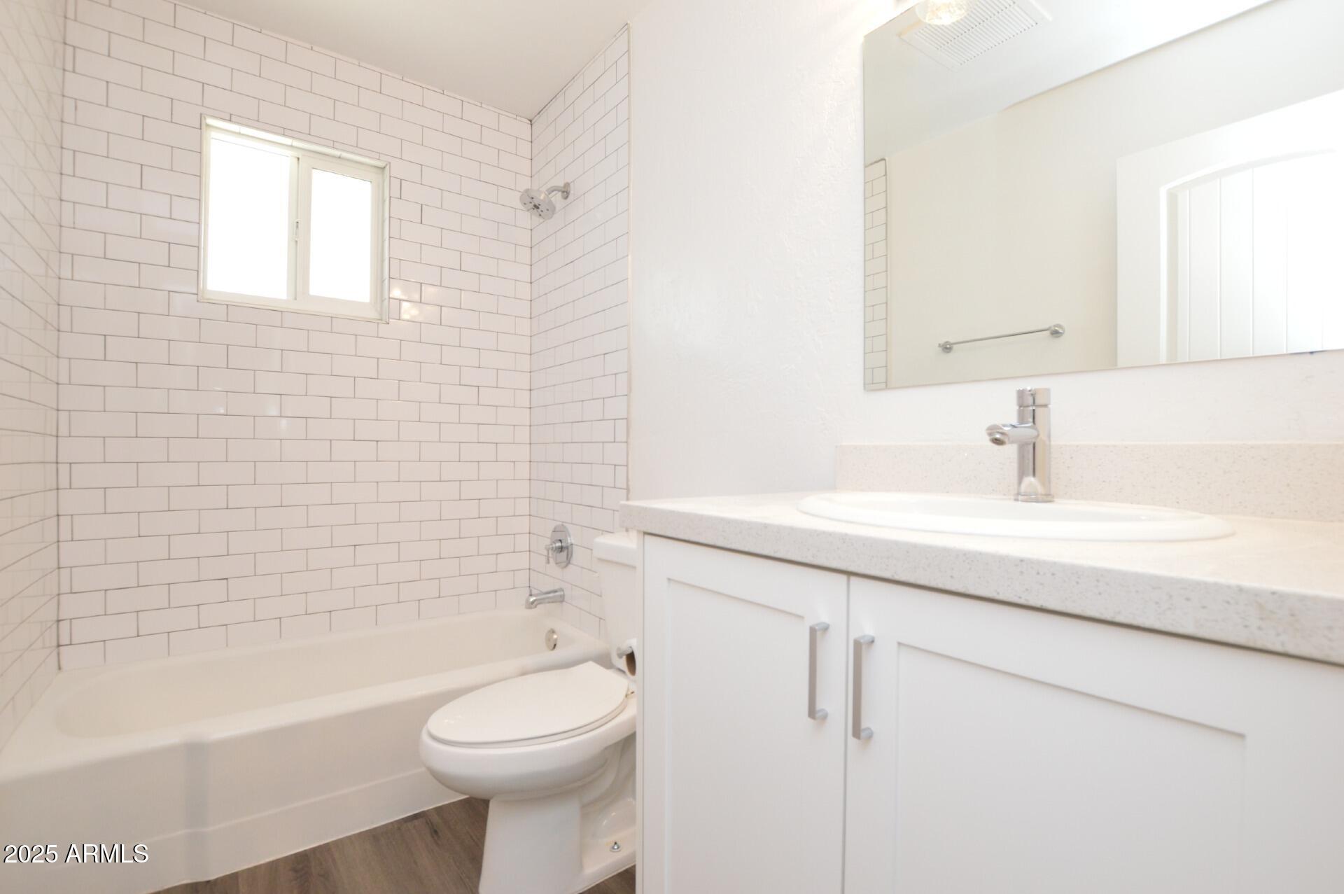 1202 East Kaler Drive, Unit 1 Phoenix, AZ 85020 - Photo 14 of 16 a bathroom with a sink a toilet and bathtub