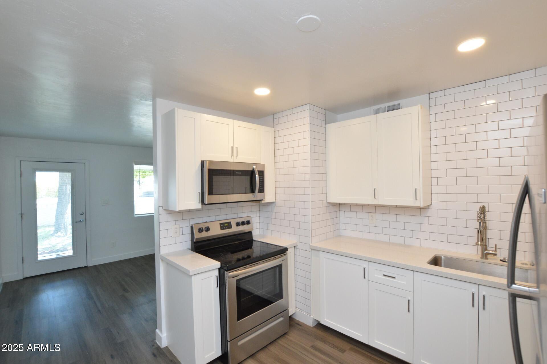 1202 East Kaler Drive, Unit 1 Phoenix, AZ 85020 - Photo 15 of 16 a kitchen with sink a microwave and cabinets