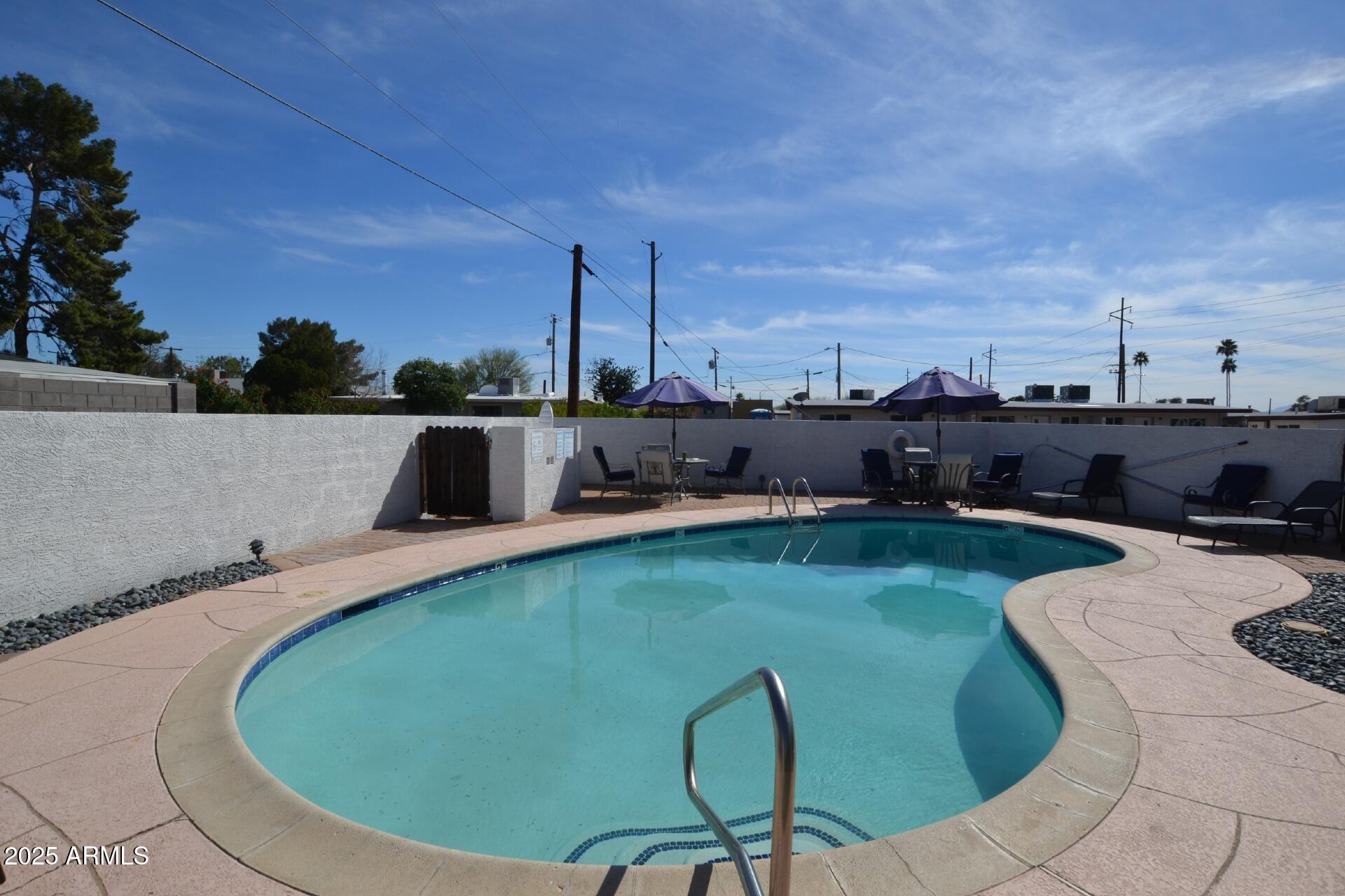 1202 East Kaler Drive, Unit 1 Phoenix, AZ 85020 - Photo 16 of 16 a view of a swimming pool with lounge chair