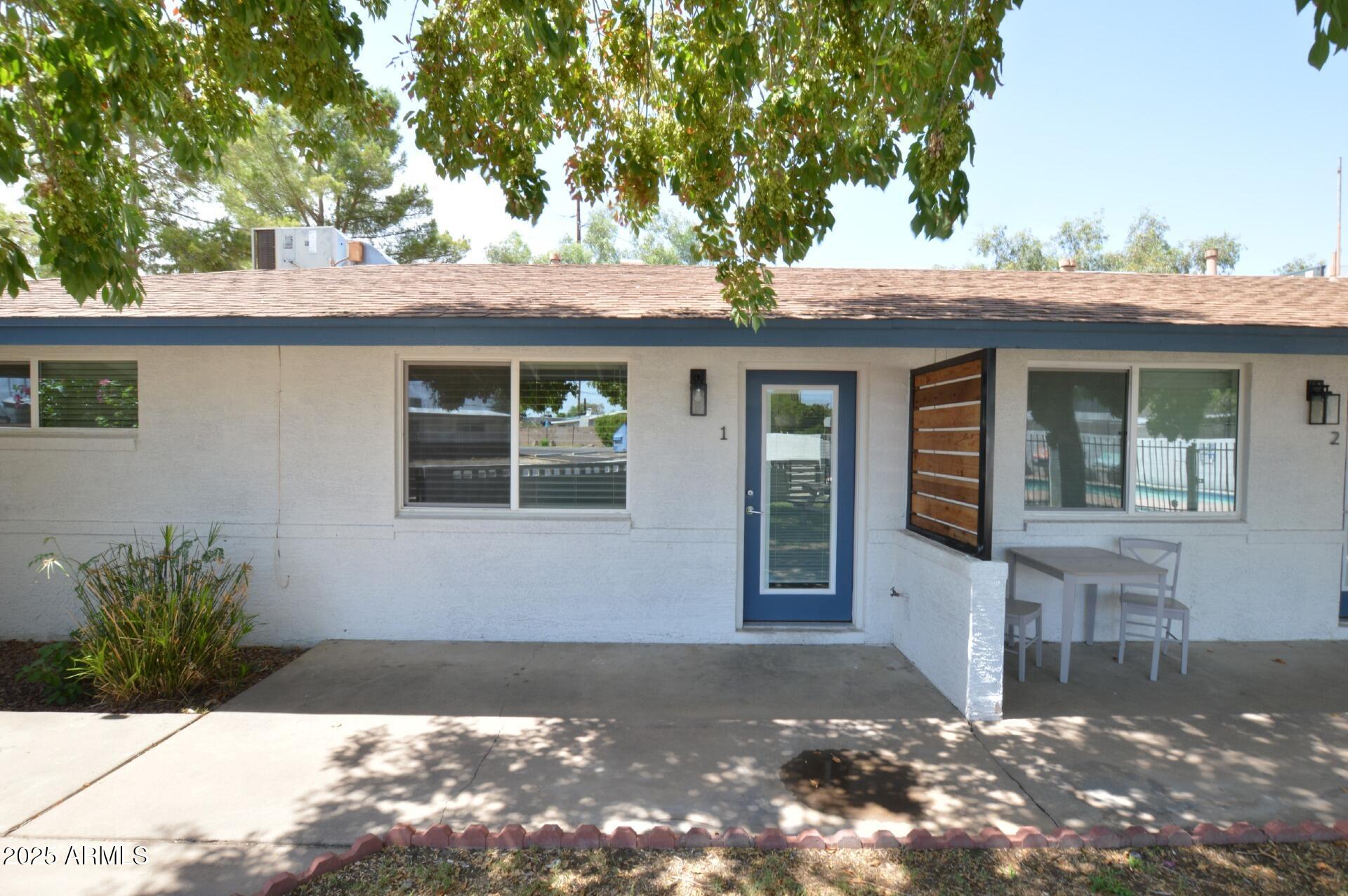 1202 East Kaler Drive, Unit 1 Phoenix, AZ 85020 - Photo 2 of 16 a front view of a house with a yard and garage