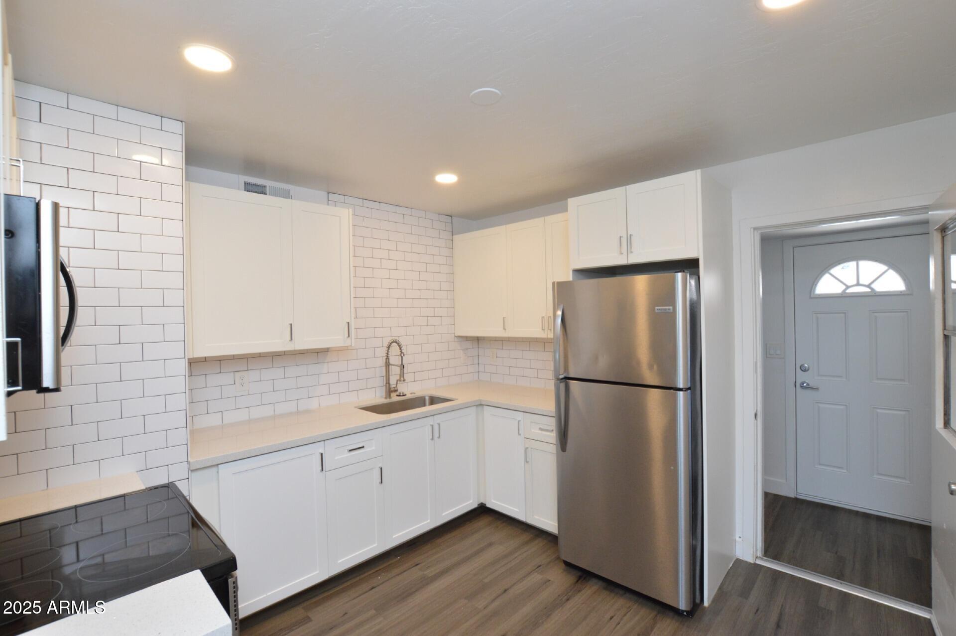 1202 East Kaler Drive, Unit 1 Phoenix, AZ 85020 - Photo 4 of 16 a kitchen with a refrigerator a sink and dishwasher