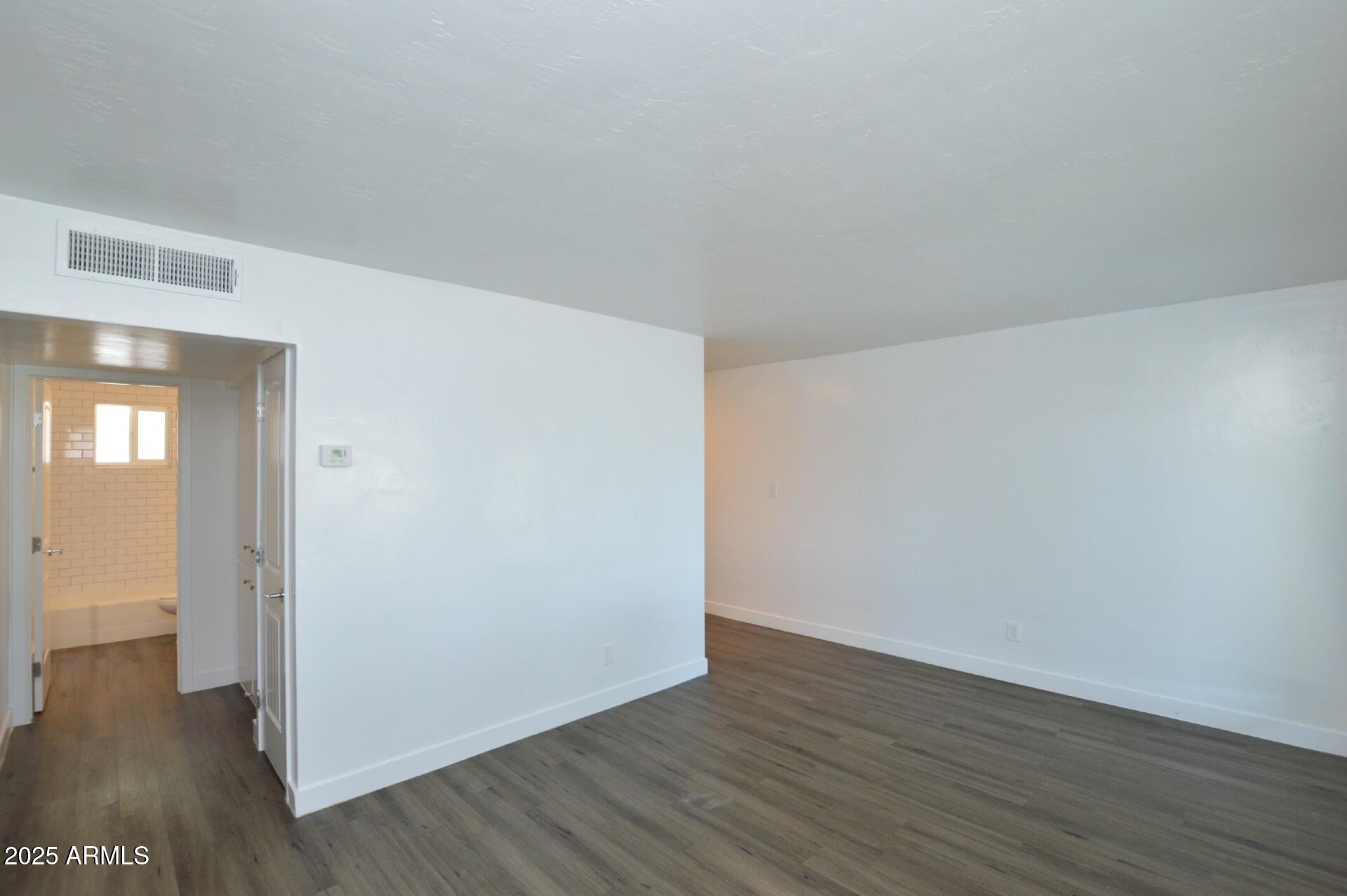 1202 East Kaler Drive, Unit 1 Phoenix, AZ 85020 - Photo 8 of 16 a view of an empty room with wooden floor