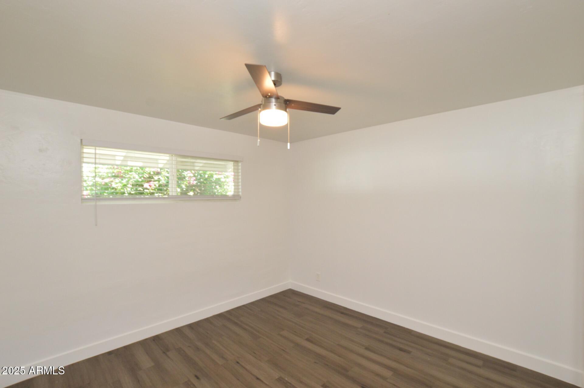 1202 East Kaler Drive, Unit 1 Phoenix, AZ 85020 - Photo 10 of 16 wooden floor in an empty room with a window