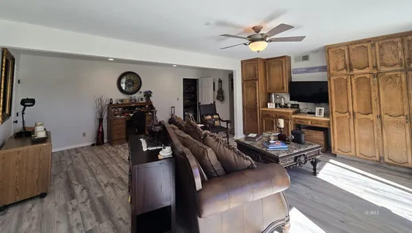 a view of a livingroom with furniture and a flat screen tv