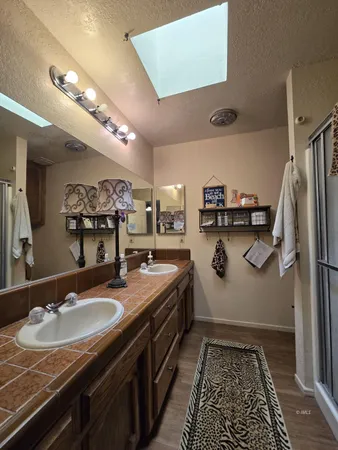 a bathroom with a sink double vanity granite and a mirror