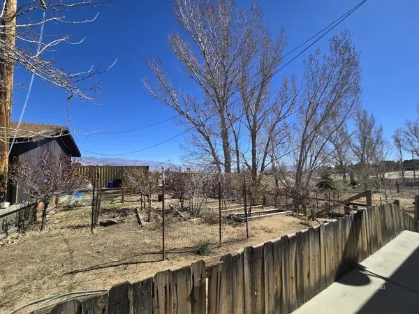 a view of a patio with wooden fence