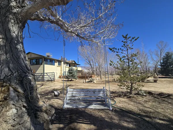 a view of a yard with wooden fence