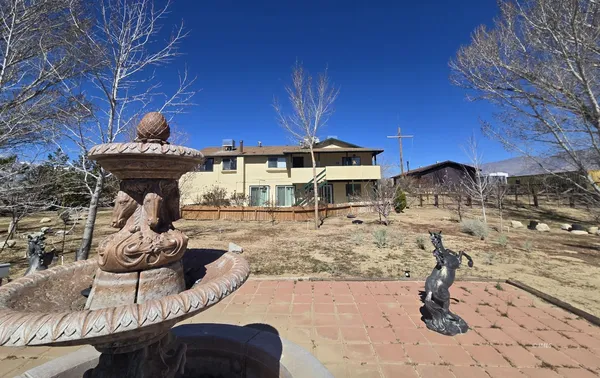 a roof deck with table and chairs a barbeque