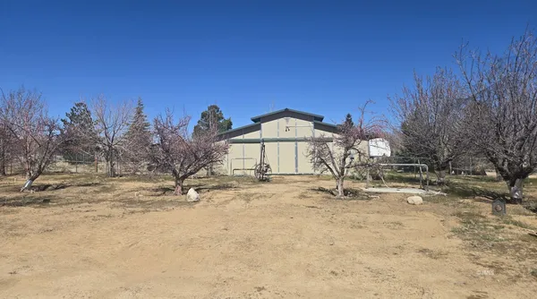 a view of a house with a snow in the background