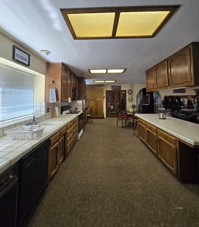 a large kitchen with lots of counter space and a sink
