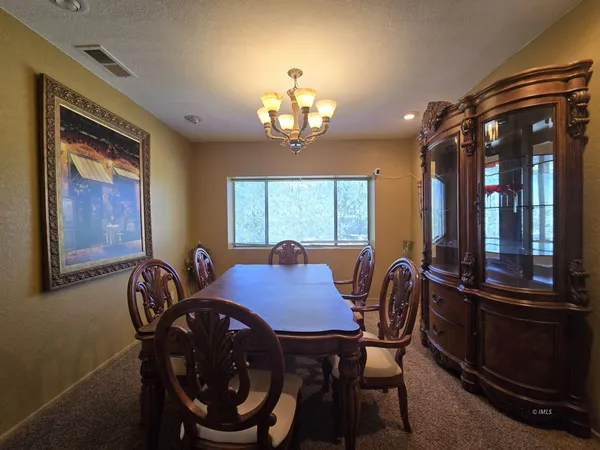a view of a dining room with furniture and window