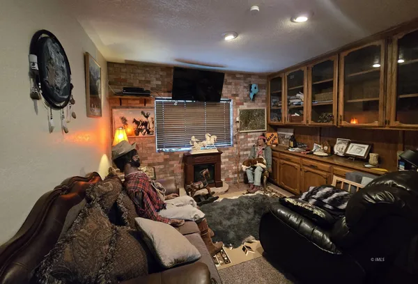 a living room with fireplace furniture and a flat screen tv