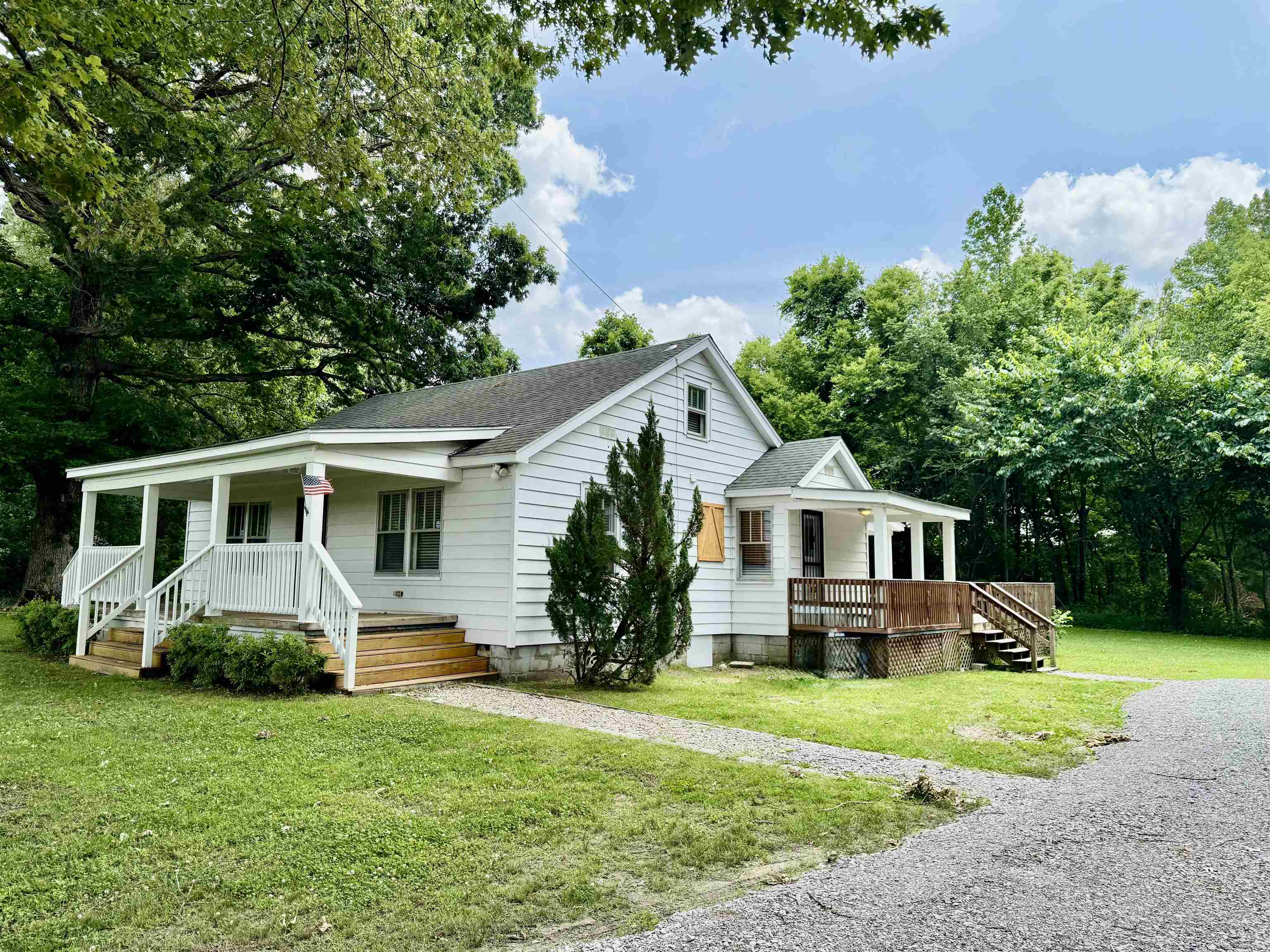 4120 Chambers Chapel Road Lakeland, TN 38002 - Photo 1 of 38 Bungalow-style house featuring a porch, roof with shingles, and a front lawn