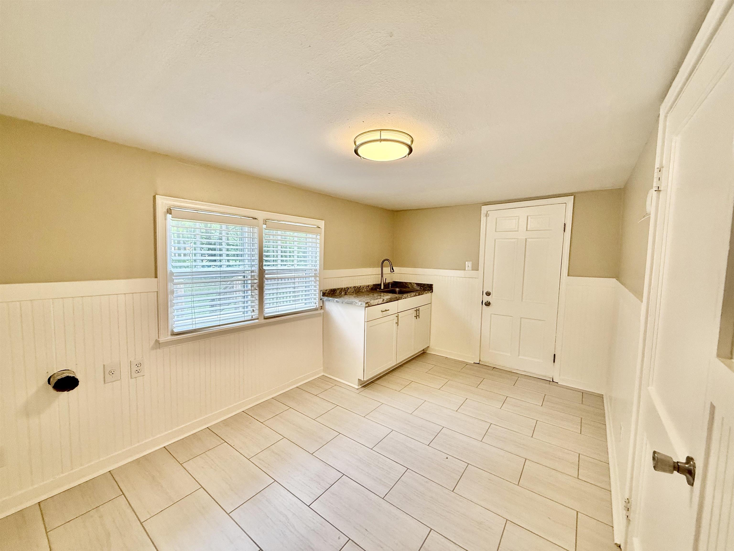 4120 Chambers Chapel Road Lakeland, TN 38002 - Photo 17 of 38 Washroom featuring a wainscoted wall and cabinet space