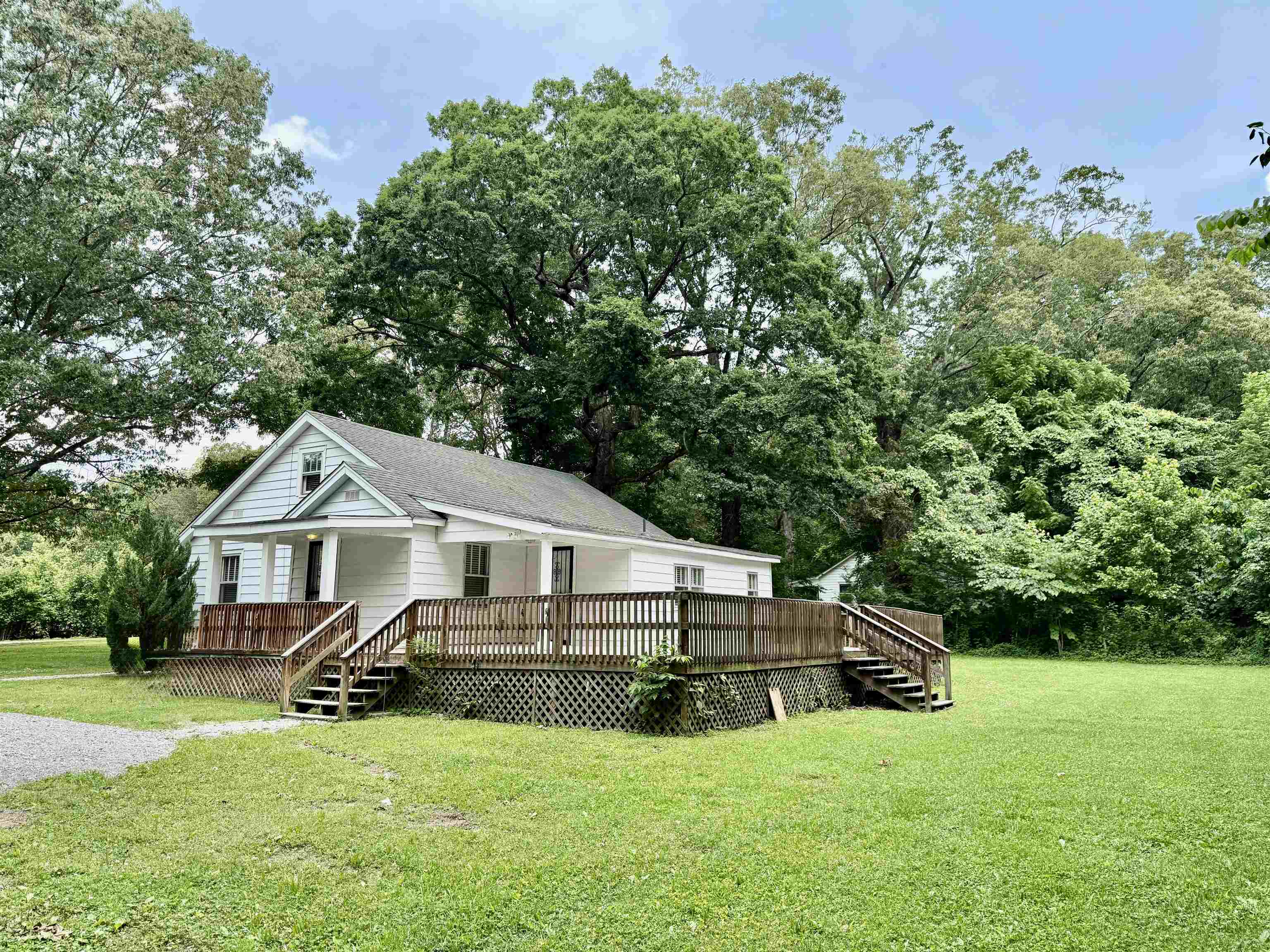 4120 Chambers Chapel Road Lakeland, TN 38002 - Photo 2 of 38 View of front of property with a front yard, a deck, and view of wooded area