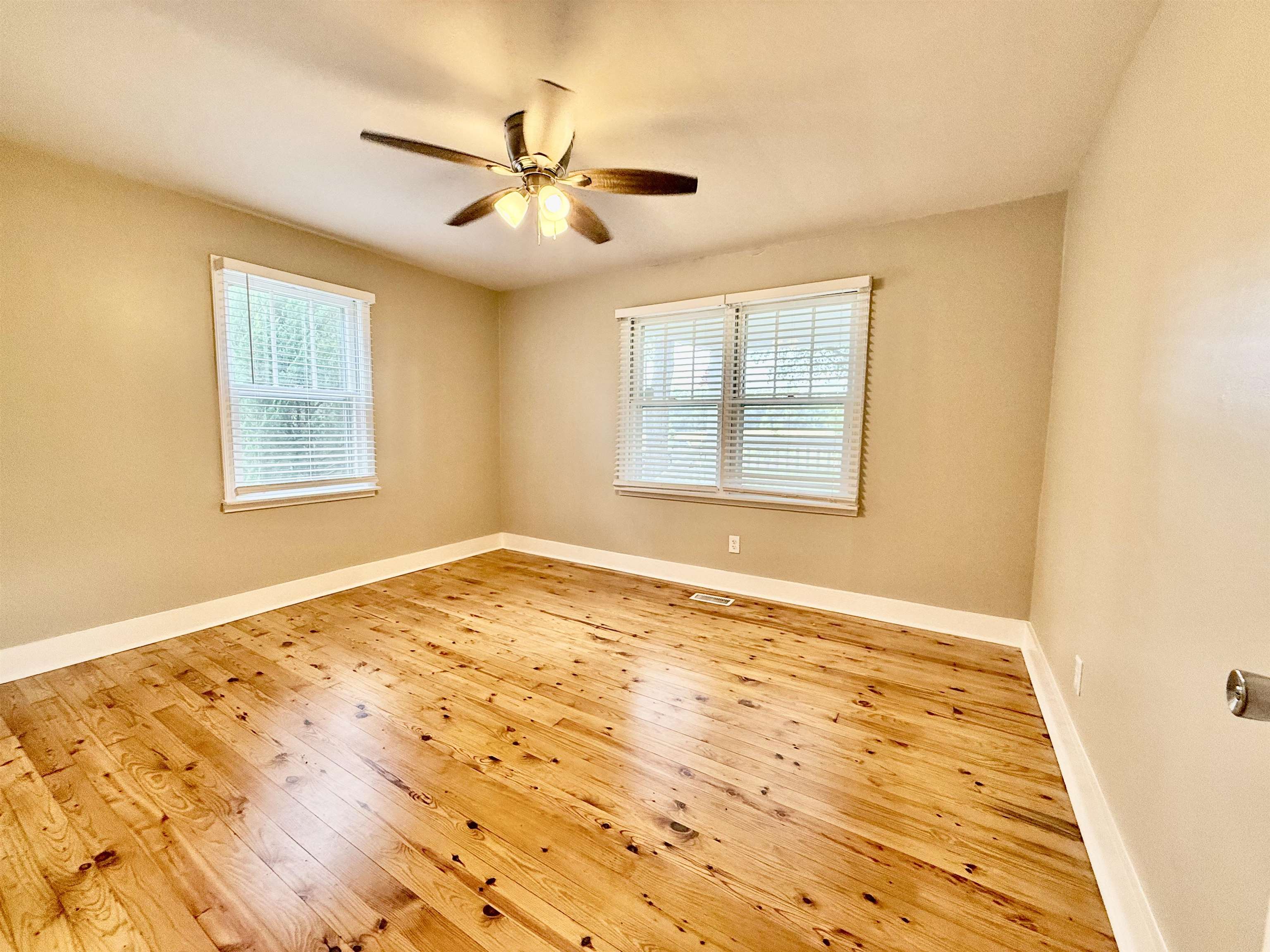 4120 Chambers Chapel Road Lakeland, TN 38002 - Photo 22 of 38 Unfurnished room featuring healthy amount of natural light, hardwood / wood-style flooring, a ceiling fan, and baseboards