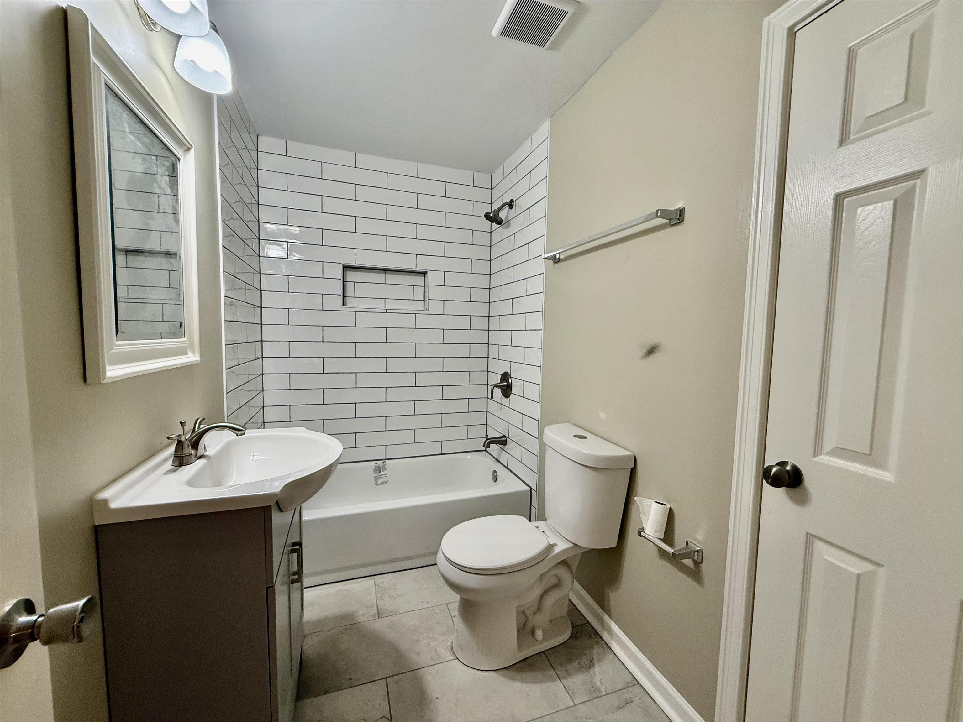 4120 Chambers Chapel Road Lakeland, TN 38002 - Photo 23 of 38 Bathroom with vanity, toilet, shower / washtub combination, baseboards, and tile patterned floors