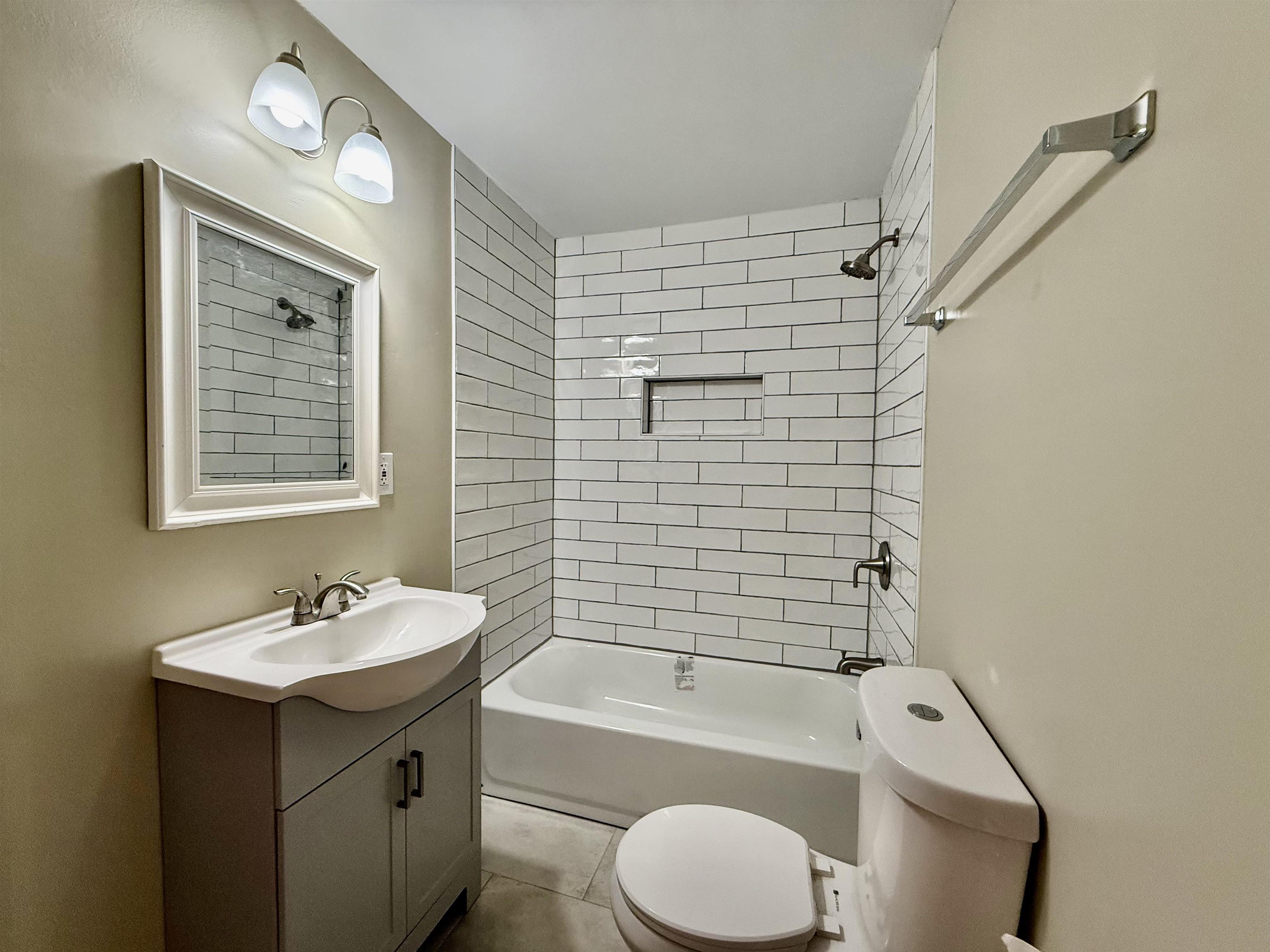 4120 Chambers Chapel Road Lakeland, TN 38002 - Photo 24 of 38 Bathroom featuring toilet, vanity, tub / shower combination, and tile patterned floors