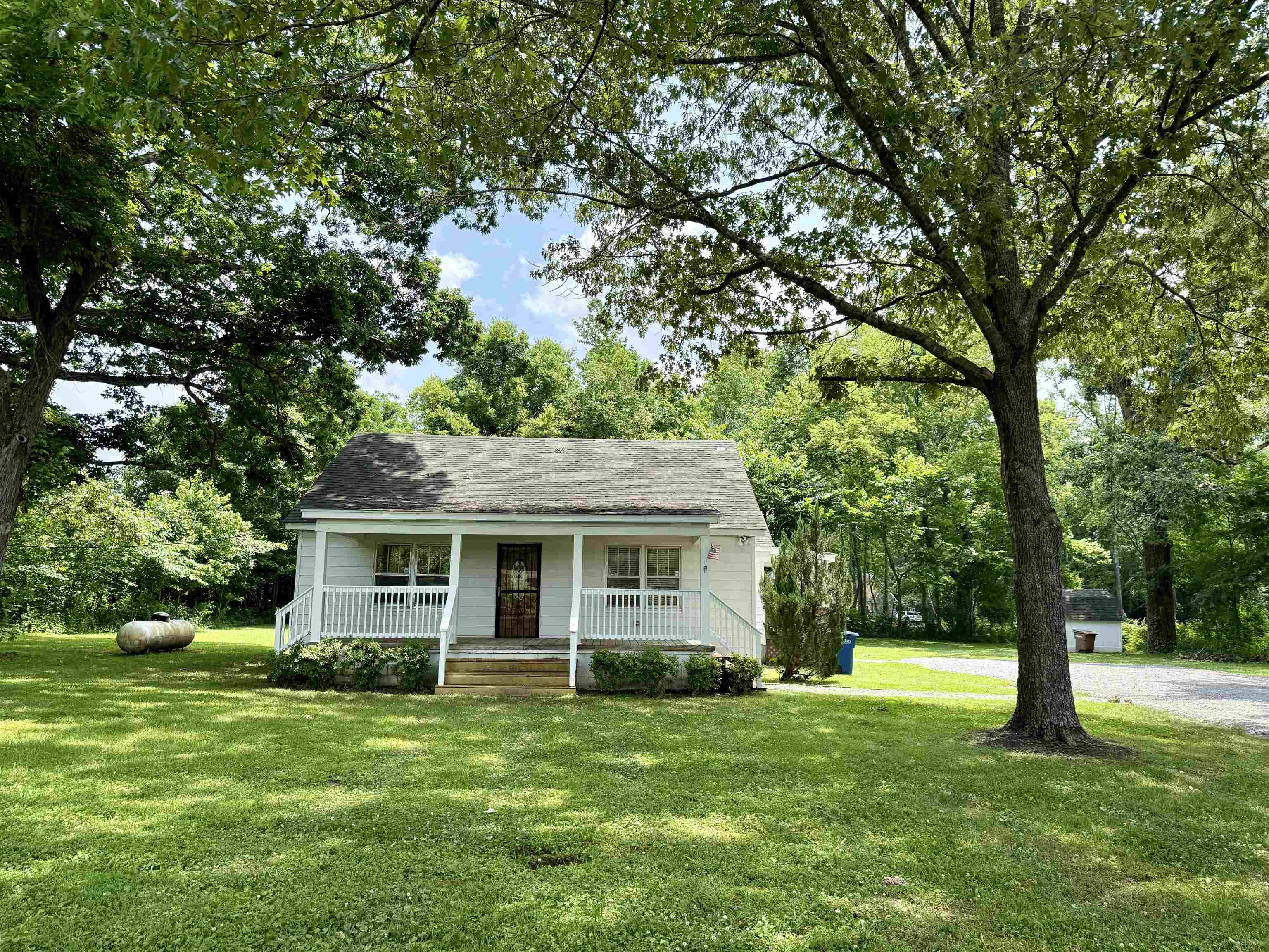 4120 Chambers Chapel Road Lakeland, TN 38002 - Photo 29 of 38 Bungalow with a porch, a front yard, view of scattered trees, and a shingled roof