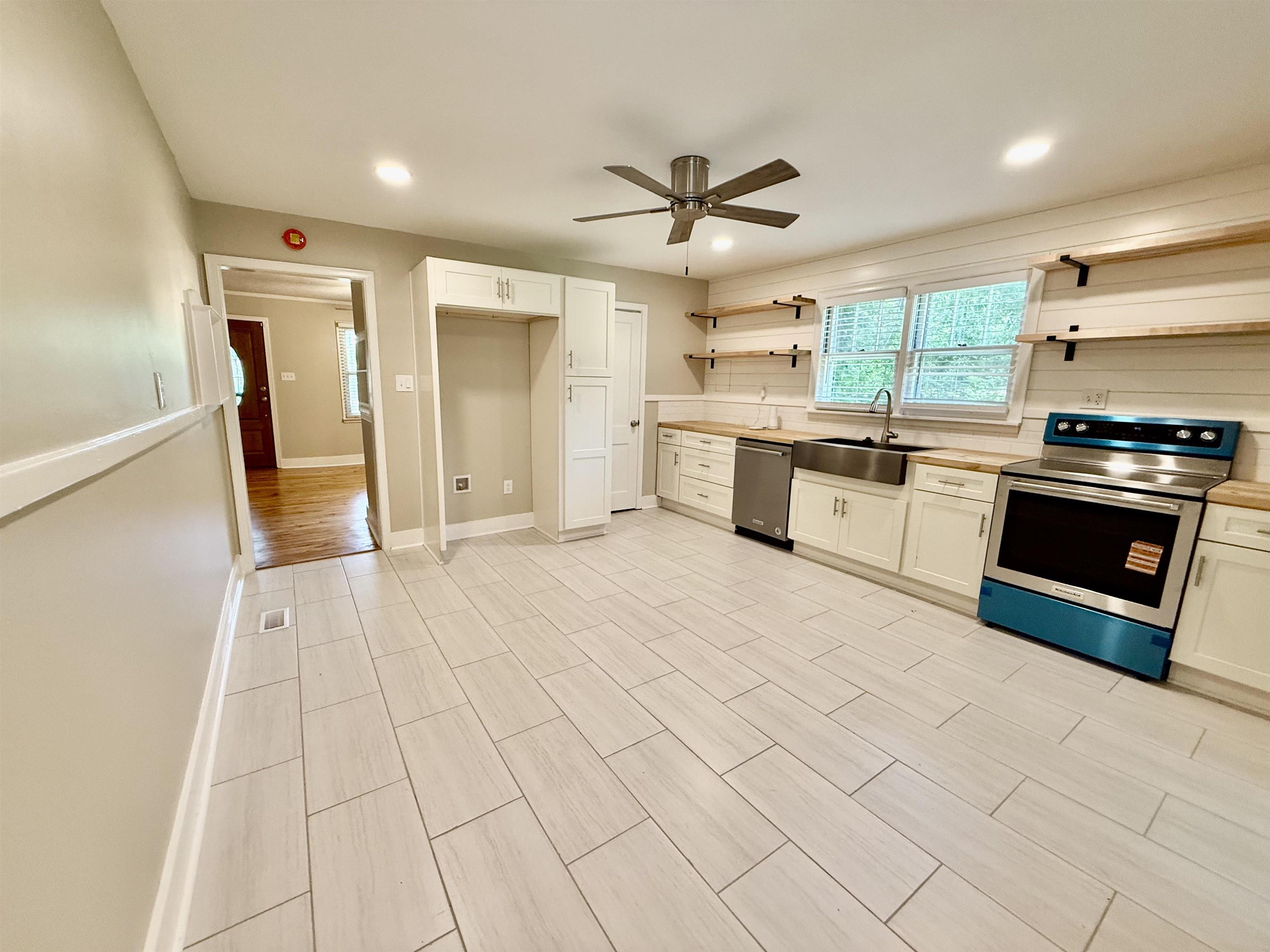 4120 Chambers Chapel Road Lakeland, TN 38002 - Photo 7 of 38 Kitchen with stainless steel appliances, open shelves, a sink, a ceiling fan, and baseboards