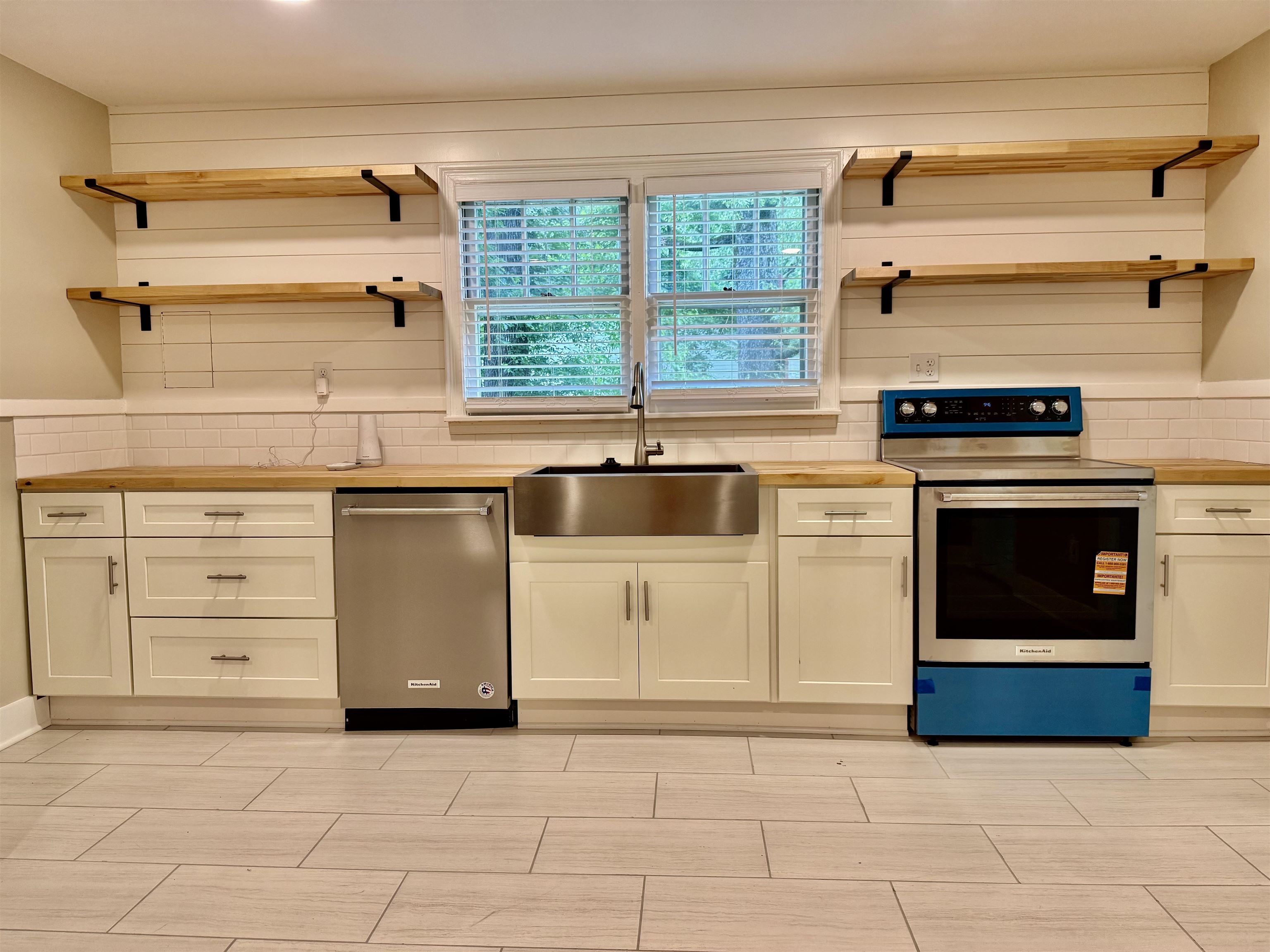 4120 Chambers Chapel Road Lakeland, TN 38002 - Photo 10 of 38 Kitchen with stainless steel appliances, open shelves, a sink, decorative backsplash, and white cabinetry